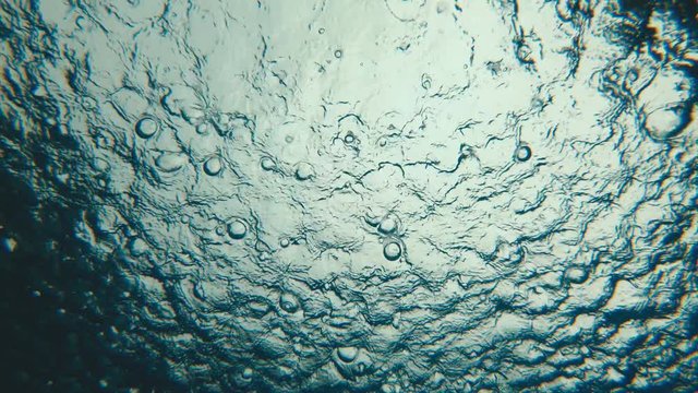 Background of rain drops from underwater water surface, slow motion