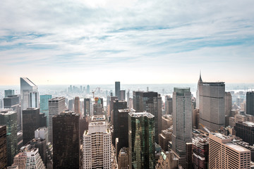 Fototapeta na wymiar New York City Manhattan, NYC/ USA - 08 21 2017: Top of the Rock panorama view over skyline from Rockefeller center to NYC and the Empire State building on a light cloudy sunny day with blue sky