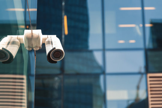 Security surveillance system at the entrance to a modern office building. Two cameras of video surveillance.