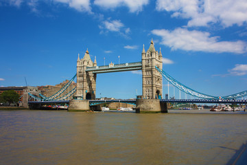 Fototapeta na wymiar The famous London Bridge on a blue sky summer day. The tranquil water of the Thames river