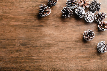 Pine cones on wood background. Christmas decoration with copy space