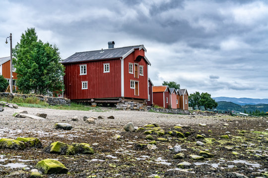 The fishermen's houses close to river Vefsna, in Sjogata, city Mosjoen, Norway. This old house has built in traditional scandinavian style - red and wooden, some white decoration panels