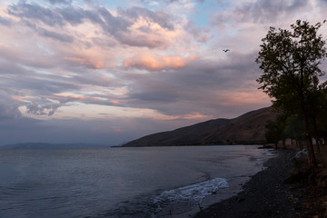Fototapeta premium Beautiful sunset at the lake. Amazing colorful clouds after sunset at the Sevan lake Armenia.