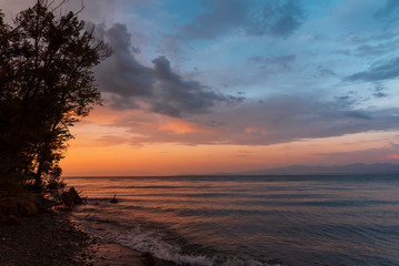 Beautiful sunset at the lake. Amazing colorful clouds after sunset at the Sevan lake Armenia.