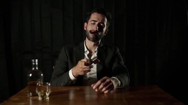 man with cigar and a glass whiskey in a dark room