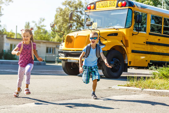 Elementary School Kids Leaving School To Get The School Bus