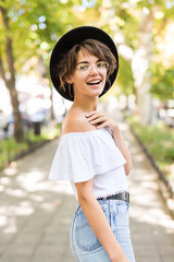 Attractive young woman enjoying her time outside in summer park