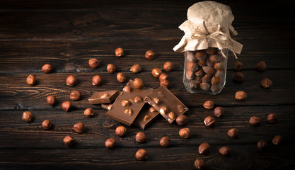 chocolate with hazelnuts on a wooden background