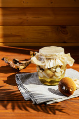 Marinated mushrooms in a jar on a wooden table. Fermented food.