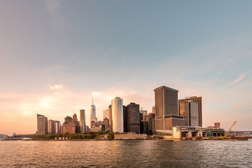 Obraz premium New York City New Jersey, NYC/ USA - 08 21 2017: Amazing sunset on New York City Hudson River on public transport staten island ferry with beautiful panorama view to NYC Manhattan skyline
