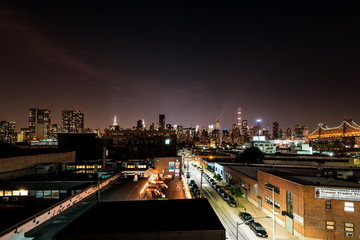 Long island City, New York City/ USA - 08 21 2017: View to the Queensboro Bridge in LIC NYC Big Apple at an bright night sky with skyscrapers and the amazing skyline of Manhattan in background