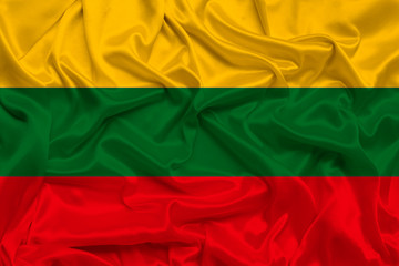 beautiful photo of the national flag of Lithuania on delicate shiny silk with soft draperies, the concept of state power, country life, horizontal, close-up, copy space