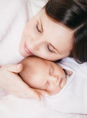 Young happy mother with baby girl