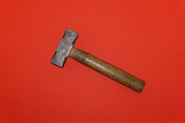 Brown handle hammer on a red background