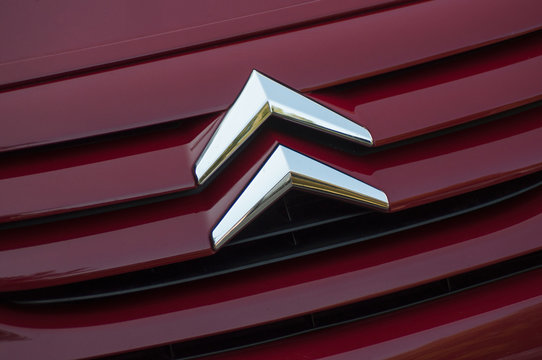 Mulhouse - France - 28 August 2019 - Closeup of Citroen logo on purple Citroen C2 front parked in the street