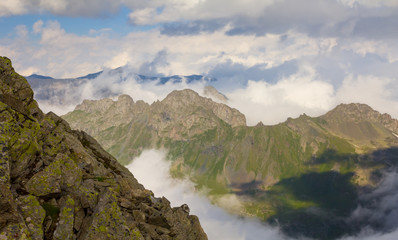 Naklejka na ściany i meble mountain chain in a dense clouds, natural outdoor scene