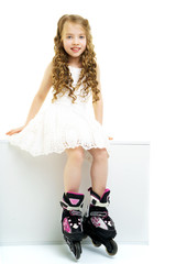 Little girl on roller skates.