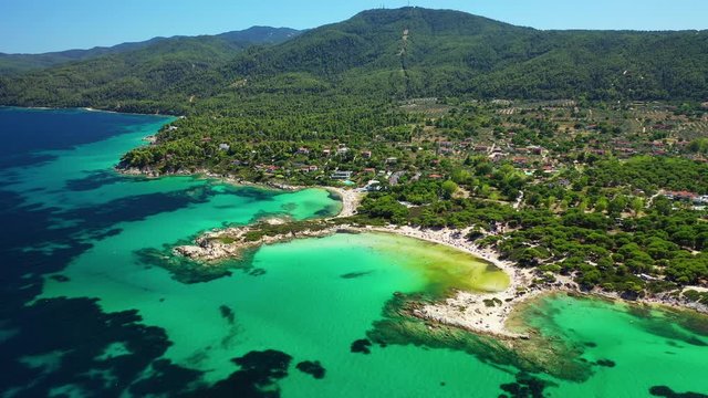 Aerial drone view video of iconic turquoise paradise bay and twin beaches of Karidi and small Karidi, Sithonia peninsula, Halkidiki, North Greece