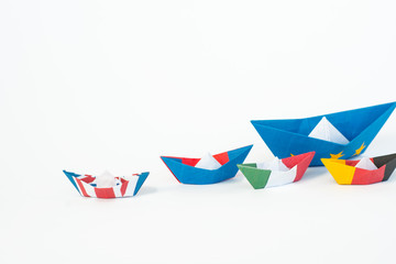 paper ships from the flags of the European Union and the UK and other countries of europe on white background, concept of an agreement on Brexit