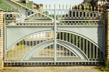 Obraz premium metal fence with decorative elements in the daytime in summer