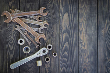 Rusty Old Tools on black vintage wood background.