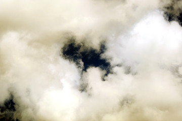White fluffy clouds on a dark background