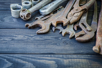 Rusty Old Tools on black vintage wood background.