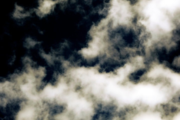 White fluffy clouds on a dark background