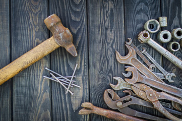 Rusty Old Tools on black vintage wood background.