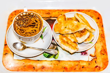 Two cups of coffee and cookies on a tray