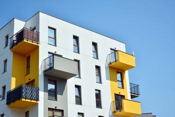 Modern apartment buildings on a sunny day with a blue sky. Facade of a modern apartment building