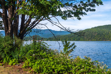 View over Burrard Inlet, ocean and island with boat and mountains in beautiful British Columbia. Canada.