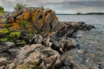 Highly contorted multi-banded gneiss along the shore of an island in the Georgian Bay, Ontario....