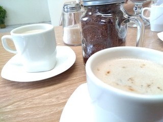 cup of coffee with milk and chocolate cookies