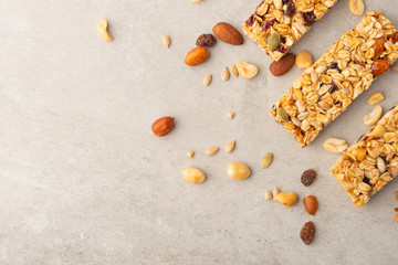 granola bars with nuts on a light background with space for design, horizontal photo, diet, proper nutrition