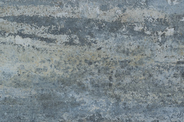 Old gray wall with yellow and brown spots as an abstract background