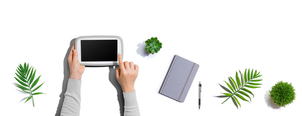 Person using a tablet computer from above