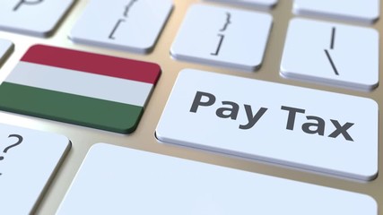PAY TAX text and flag of Hungary on the buttons on the computer keyboard. Taxation related conceptual 3D animation