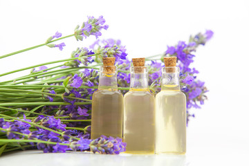 Obraz na płótnie Canvas lavender essential oil in beautiful bottle on White background