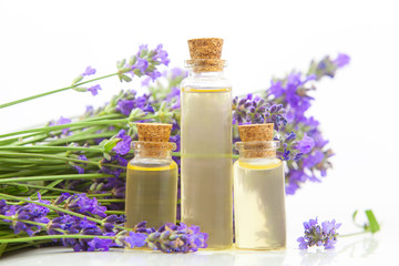 Fototapeta na wymiar lavender essential oil in beautiful bottle on White background