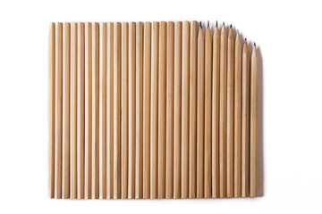 new and used wooden pencils lie nearby . on a white background