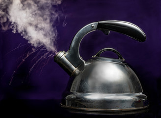 Vintage tea pot venting steam.