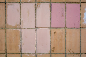 Vertical orange concrete tiles brick wall, pink paint. Text copy space