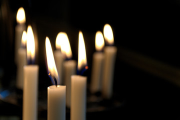 white candles in the Church on a dark background close-up