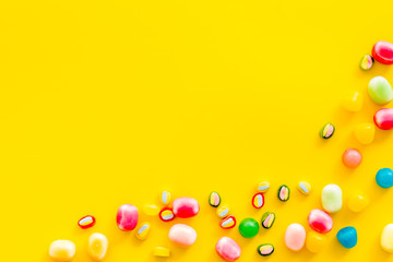 Candies for party design on yellow background top view copyspace