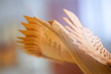 Wooden bird of happiness on a light background. Slavic folk traditional symbolism. Shallow depth of field