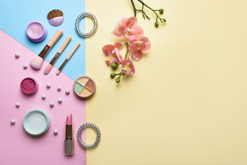 Set of decorative cosmetics with accessories on color background