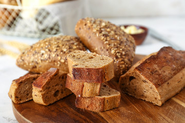 Slices of tasty bread on wooden board