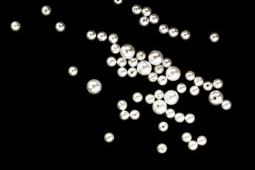 scattered pearls on a black background