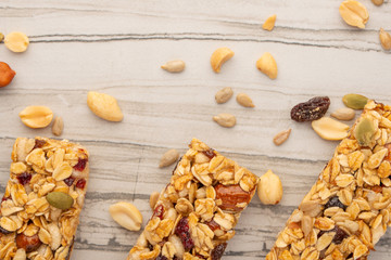 granola bars with nuts on a light background with space for design, horizontal photo, diet, proper nutrition